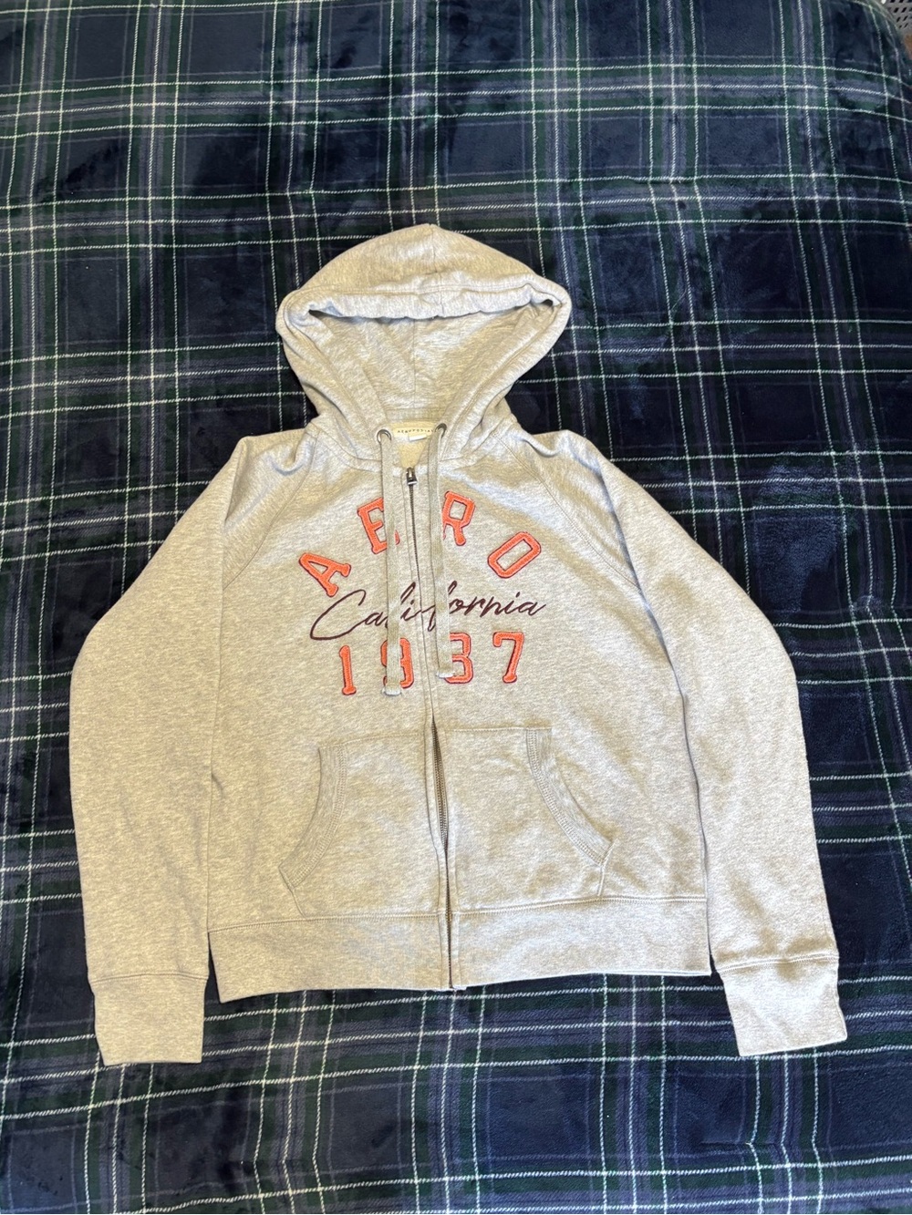 Women’s Aeropostale grey zip up hoodie w/front graphic.Size L.